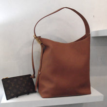 Load image into Gallery viewer, This Louis Vuitton Vintage Cognac Padlock Low Key Hobo MM is in a cognac color. The included pochette is in the original Louis Vuitton pattern and color. The shoulder strap is the same material as the bag.
