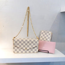 Load image into Gallery viewer, This Louis Vuitton Vintage Damier Azur F`elicie Pochette  has a long shoulder chain in gold hardware. It also includes a pink cardholder and a pouch in damier azur. The interior of the Pochette is pink.
