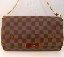 Load image into Gallery viewer, This Louis Vuitton Damier Ebene Favorite MM has gold hardware which includes a thin shoulder chain and Louis Vuitton name plate on the clasp. The interior of this bag is red.
