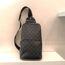 Load image into Gallery viewer, This Louis Vuitton  Vintage Damier Graphite Sling Bag has a top and middle zippered compartment and a sturdy canvas strap. It has two interchangable rings on the bottom for hooking the strap.
