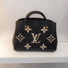 Load image into Gallery viewer, This Louis Vuitton Vintage Empreinte Leather Monogram Montaigne BB is black with large cream color monogram. It has two carrying handles on the top of the bag, a top zippered opening and gold hardware.  The interior of this bag is a soft red.
