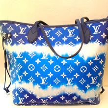 Load image into Gallery viewer, This Louis Vuitton Vintage Escale Neverfull MM with Pouch has the original monogram pattern in blue on one side of the bag and the larger monogram pattern  in blue on the other side of the bag. It also includes a pouch which has the same blue monogram patterns- one side regular size monogram and the other side larger monogram pattern.  The inside of this bag is an azure blue with blue stars.
