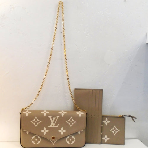 This Louis Vuitton Vintage F`elicie Pochette is camel color with cream monogram. It has gold hardware including a shoulder chain. Included with this pochette is a camel card holder and pouch. The pouch also has the cream monogram design. The interior of this Pochette is cream.