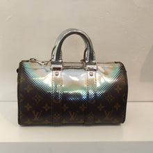 Load image into Gallery viewer, This Louis Vuitton Vintage Iridescent Metallic Speedy Bandouliere has a frosting of silver over top of Louis Vuitton original monogram. It has double carrying handles and a belt shoulder strap. The interior of this bag is black.
