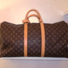 Load image into Gallery viewer, This Louis Vuitton Vintage Monogram Keepall 55 is extra roomy and is one of the largest sizes! It has a buckle attached to the handles to secure them. The bag itself is in excellent condition.
