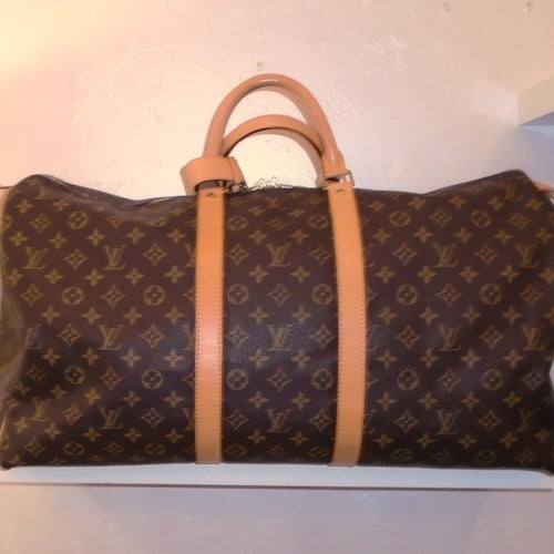 This Louis Vuitton Vintage Monogram Keepall 55 is extra roomy and is one of the largest sizes! It has a buckle attached to the handles to secure them. The bag itself is in excellent condition.