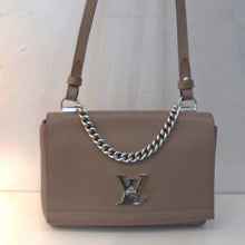 Load image into Gallery viewer, This Louis Vuitton Vintage Lockme II BB is a dove brown color and has silver hardware which includes the Louis Vuitton logo latch on the front flap. It has a leather shoulder strap and a carrying chain. The interior is the same color as the outside of the bag.
