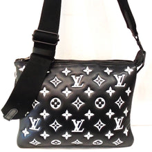 Load image into Gallery viewer, This Louis Vuitton Vintage Lambskin Monogram Coussin PM is black with Large white Monogram imprinted in the leather. It has a sturdy black adjustable guitar strap/shoulder strap. The bag is in three sections and has a burnt orange interior.
