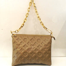 Load image into Gallery viewer, This Louis Vuitton Vintage Lambskin Taupe Coussin PM is embossed with the monogram pattern. It comes with  a heavy large link gold detachable shoulder chain and a Louis Vuitton Guitar Strap.  This bag also has its original box and dust cover. The interior of this bag is a soft navy blue. 
