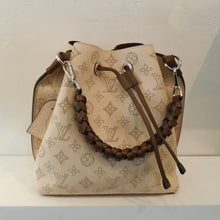 Load image into Gallery viewer, This Louis Vuitton Vintage Muria Bucket Bag Mahina Leather is a cream color in the large Louis Vuitton Monogram pattern. It has dark brown trim which includes the strap that gathers the top of the bag and the braided shoulder strap. The interior of this bag is dark brown.
