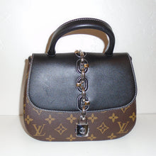 Load image into Gallery viewer, This Louis Vuitton Vintage Monogram/Black Leather Chain IT PM is in the original Louis Vuitton Monogram with a black front flap that goes halfway down the back of the bag. It has a black carrying handle, a silver lock latch and a chain that goes from front center of the bag to the back center of the bag. The interior of this bag is black.

