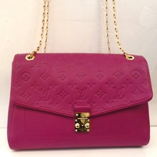 Load image into Gallery viewer, This Louis Vuitton Vintage Empreinte Saint Germain MM is a red-plum color and the flap has the monogram pattern embossed in the leather. The remainder of the bag is smooth leather. It has gold hardware which includes a shoulder chain and the front clasp. The design of the front clasp has a triangle that fits between two posts, one of which is stable. The interior of this bag is a soft plum color.
