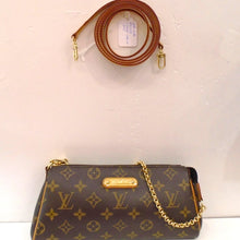 Load image into Gallery viewer, This Louis Vuitton Vintage Monogram Eva with Leather Shoulder Strap is in the original Monogram in shades of brown. It has tan  trim and the detachable Leather shoulder strap is also tan. It has a thin Louis Vuitton gold plaque and the hardware is also gold. The interior of this bag is soft tan.
