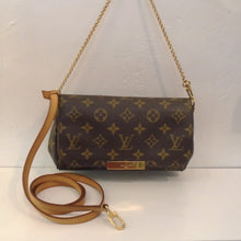 Load image into Gallery viewer, This Louis Vuitton Vintage Monogram Favorite PM is dark brown with original monogram pattern and a full flap. It has gold hardware which includes the shoulder chain and comes with a detachable camel brown leather shoulder strap. The interior is red. This bag has been discontinued.
