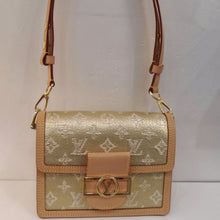 Load image into Gallery viewer, This Louis Vuitton Vintage Monogram Jacquard Mini Dauphine is gold with cream monogram. It has light camel trim and gold hardware. The clasp is a gold rectangle with a circle in its middle and  Louis Vuitton Logo in the center. The interior is camel.
