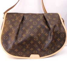 Load image into Gallery viewer, This Louis Vuitton Vintage Monogram Menilmontant MM has the original monogram pattern, camel trim and gold hardware. This bag has a plump full flap in the front of the bag. It has an adjustable shoulder strap and a zippered pocket on the outside back of the bag. The interior is a chocolate brown.
