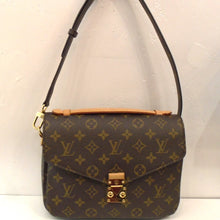 Load image into Gallery viewer, This Louis Vuitton Monogram Metis Pochette is in the traditional monogram style with a sturdy adjustable and removable strap. It has an interlocking snap front latch and a dark brown soft interior.
