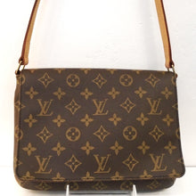 Load image into Gallery viewer, This Louis Vuitton Vintage Monogram Musette Tango Shoulder Bag is in the original brown tone monogram pattern. It has gold hardware and camel trim. It has an adjustable buckle shoulder strap and a deep brown interior.
