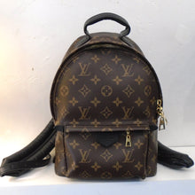 Load image into Gallery viewer, This Louis Vuitton Vintage Monogram Palm Springs Backpack MM has gold hardware and black trim. It has a zippered pocket in the front of the backpack. The front has a zippered opening and it has a sturdy loop on the top of the bag for hanging. It has sturdy black arm/shoulder straps on the back of the bag.
