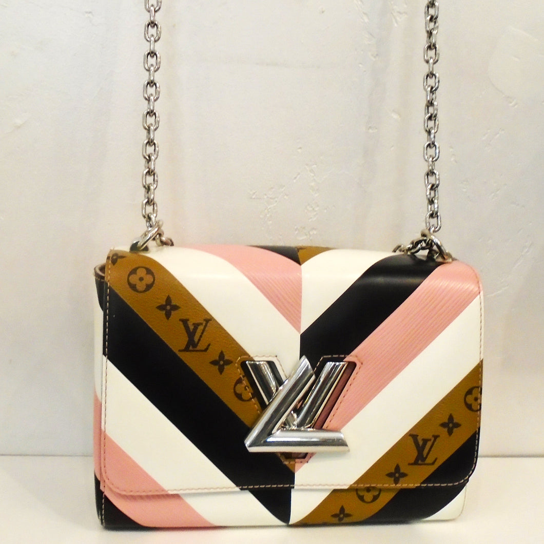 This Louis Vuitton Vintage Monogram/Reverse Epi Twist has the color of pink, white, black and brown in alternating colors in the chevron design with the monogram pattern on the brown. It has the Louis Vuitton logo as the front latch in silver along with a silver shoulder chain. The interior of this bag is light pink..