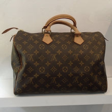 Load image into Gallery viewer, This Louis Vuitton Vintage Monogram Speedy 35 is a handbag although is has the appearance of a duffel bag. It is in the original Louis Vuitton monogram pattern and has camel double carrying handles. The interior of this bag is also camel.
