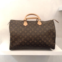 Load image into Gallery viewer, This Louis Vuitton Vintage Monogram Speedy 40 is in brown monogram, camel trim and gold hardware.  It has sturdy double handles and a zipper lock is included. The interior of this bag is cream.
