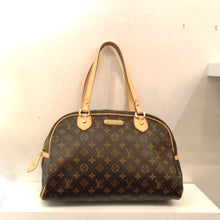 Load image into Gallery viewer, This Louis Vuitton Vintage Moogram Motorgueil GM  has the basic color monogram with the camel trim. The hardware is gold including the small Louis Vuitton name plate on the front of the bag. The interior of the bag is a soft camel.
