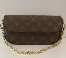Load image into Gallery viewer, This Louis Vuitton Vintage Monogram WOC has an adjustable Vachetta strap along with  shoulder chain. The interior of this bag is brown with a zippered pocket and card holders.
