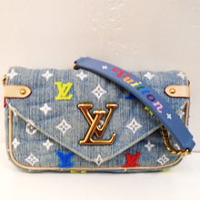 Load image into Gallery viewer, This Louis Vuitton Vintage New Wave Denim WOC has the small monogram pattern in white on the denim along with the Louis Vuitton Logo stitched on it in red, blue and yellow. This bag has a gold chain shoulder strap with a blue shoulder protector with the name Vuitton colorfully stitched on it. The flap has a large gold Louis Vuitton logo in its center. The interior is blue and has card pockets.
