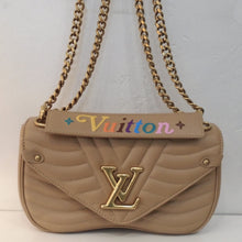 Load image into Gallery viewer, This Louis Vuitton Vintage New Wave PM is a turtle dove color with stitching on the bag that resembles waves. The middle front of the bag has stitching resembling the letter v which is right behind the Louis Vuitton logo. The bag has gold hardware and has a double shoulder chain. It has a detachable handle that has the  word vuitton stitched on it in colorful stitching. The interior of the bag is a light brown.
