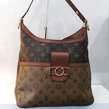 Load image into Gallery viewer, This Louis Vuitton Vintage Reverse Monogram Hobo Dauphine MM  has dark brown monogram on light brown background for the bottom half of the front of the bag. The rest of the bag is in light monogram on dark brown background. The front has a leather buckle type latch with gold buckel type design with the Louis Vuitton Logo in a circle. This bag has an adjustable  leather shoulder strap. It has dark camel trim and the interior is black.
