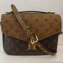 Load image into Gallery viewer, This Louis Vuitton Vintage Reverse Monogram Metis Pochette has the original Louis Vuitton monogram on light brown background from the flap to the back. The body of the bag is in the original Louis Vuitton monogram on dark brown background. It has a back zipper. The interior is a dark brown with two sections.
