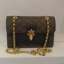 Load image into Gallery viewer, This Louis Vuitton Vintage Vavin Monogram/Black Leather bag is in the original monogram pattern with a solid black piece just under the front lip. It has gold hardware which includes the shoulder chain and the front latch. The interior and sides  of this bag are black.
