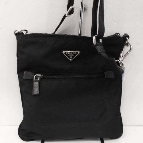 This Prada Vintage Black Nylon Front Pocket Messenger has a zippered front pocket and has the Prada emblem on the front of the bag. It has selzer hardware and a top zippered opening.