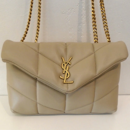 This YSL Beige Puffer Napa Lambskin/Chevron is in the Chevron pattern and has gold hardware which includes the double shoulder chain. The interior of this bag is black.