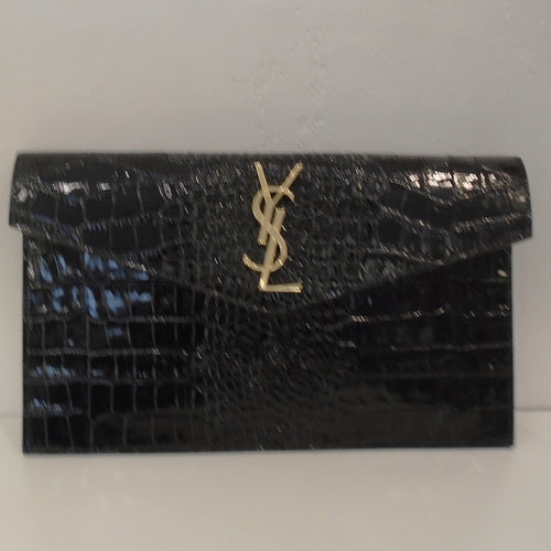 This  YSL Crocodile Embossed Uptown Clutch is black with gold hardware.