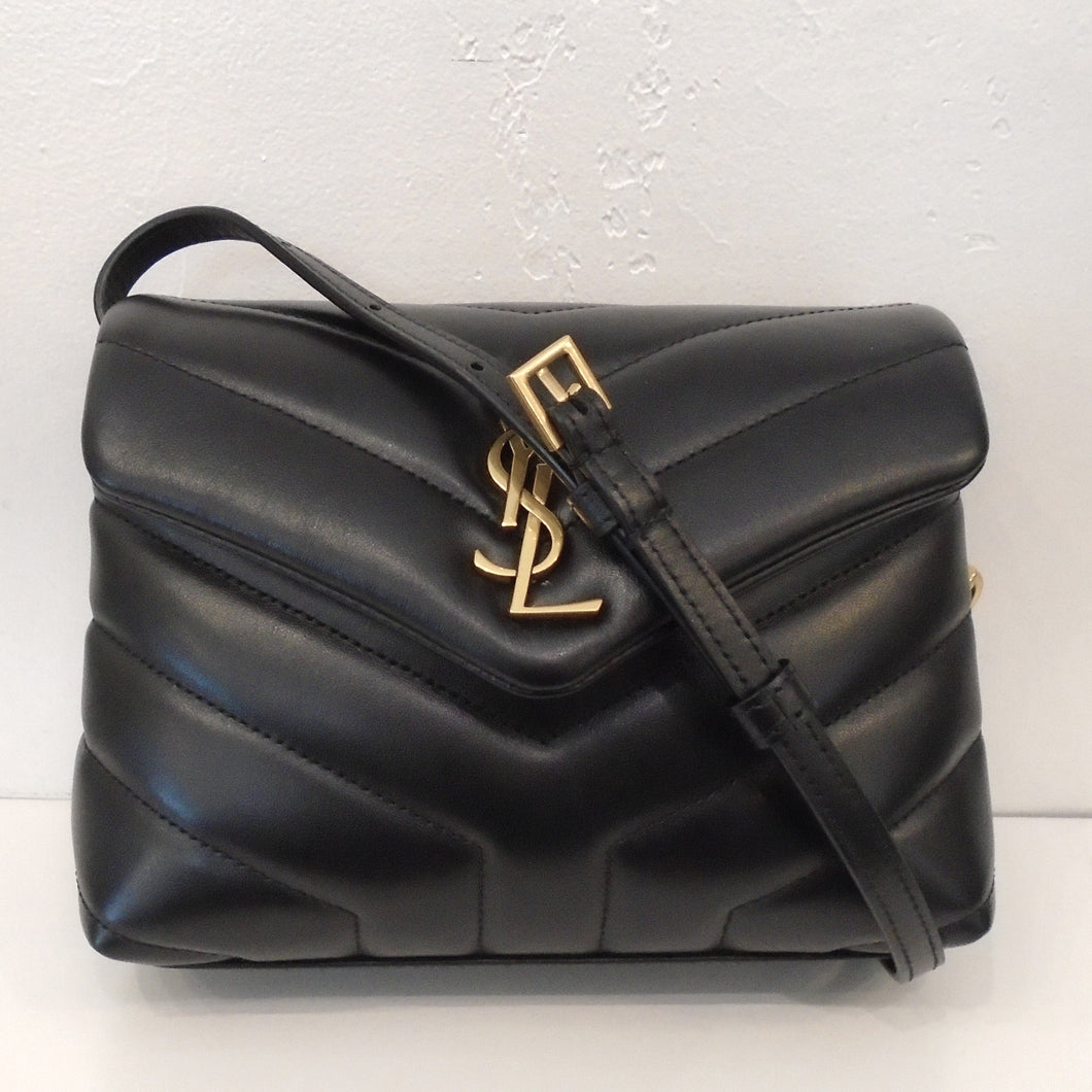 This YSL Chevron Mini Lou Lou With Gold Hardware has the YSL Logo in gold on the front flap. It has a shoulder strap and the interior of the bag is also black.