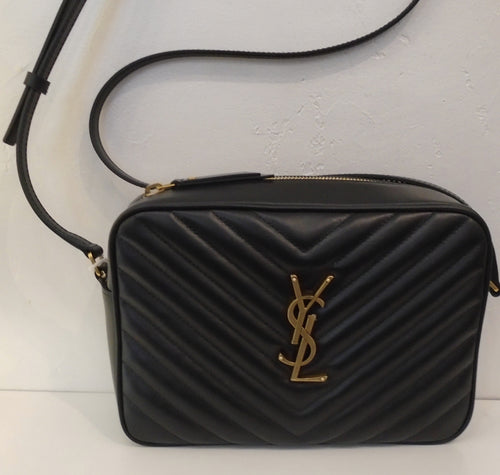 This YSL Black Loulou Camera Bag has gold hardware which includes the YSL logo on the front of the bag. It has the Chevron pattern, a top zipper and a back outside pocket. The interior is also black.