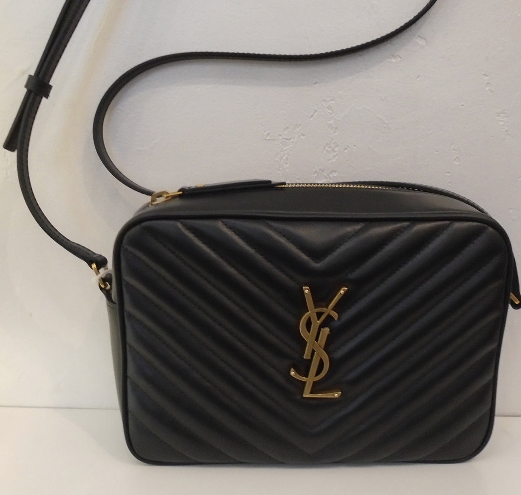 This YSL Black Loulou Camera Bag has gold hardware which includes the YSL logo on the front of the bag. It has the Chevron pattern, a top zipper and a back outside pocket. The interior is also black.