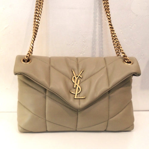 YSL Small Beige Puffer Napa Lambskin/Chevron has gold hardware including the YSL logo on the front of the bag and the double shoulder chain. The interior of this bag is black.
