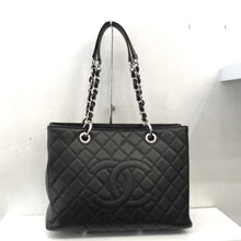 Load image into Gallery viewer, This Chanel Vintage Black Caviar Leather GST has the Chanel CCs stitched on the front of the diamond stitched bag. It has double silver chain straps with a black leather strip running through the links and shoulder guards on each chain. The back of the bag has a large pocket.
