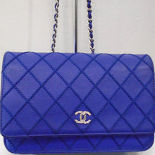 Load image into Gallery viewer, Tlhis Chanel Vintage Caviar Leather WOC is Colbalt Blue with silver hardware. The double C logo is silver with clear stones which give it a sparkle within the stitched diamond pattern. The silver shoulder strap has a cobalt Blue leather strip threaded through the chain links.
