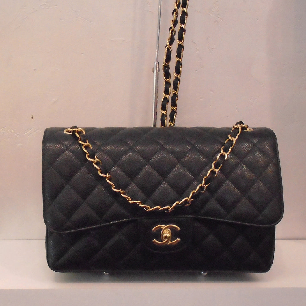 This Chanel Vintage Jumbo Black Caviar Double Flap has gold hardware and the shoulder chain has a leather strip interwoven between each link. The body of the bag is in the Diamond pattern.