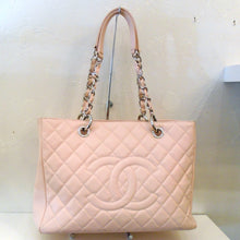 Load image into Gallery viewer, This Chanel Vintage Pink Caviar Leather GST is light pink in color, has a pink leather strip running through the silver chain of the double handle and has pink leather shoulder guards. The bag has a large pocket on the back of the bag.
