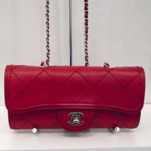 Load image into Gallery viewer, This Chanel Vintage Ultimate Stitch WOC is made of lambskin leather that is a in a sangria red color. It has silver hardware which includes the double C logo clasp and shoulder chain. A sangria red leather shoulder guard is included on the chain along with a leather strip threaded between the links of the shoulder chain. There is a pocket on the back of the bag made of the same material as the bag.
