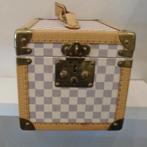 This Louis Vuitton Vintage Damier Azur Vanity Trumk has camel trim and gold hardware. It comes with a key and inside wooden case. The inside also contains a guard for three bottles to stand upright.