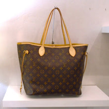 Load image into Gallery viewer, This Louis Vuitton Vintage Monogram Neverfull MM is in the traditional brown monogram pattern with camel trim. It has leather side laces to help secure the opening. This bag is lined with a soft brown fabric.
